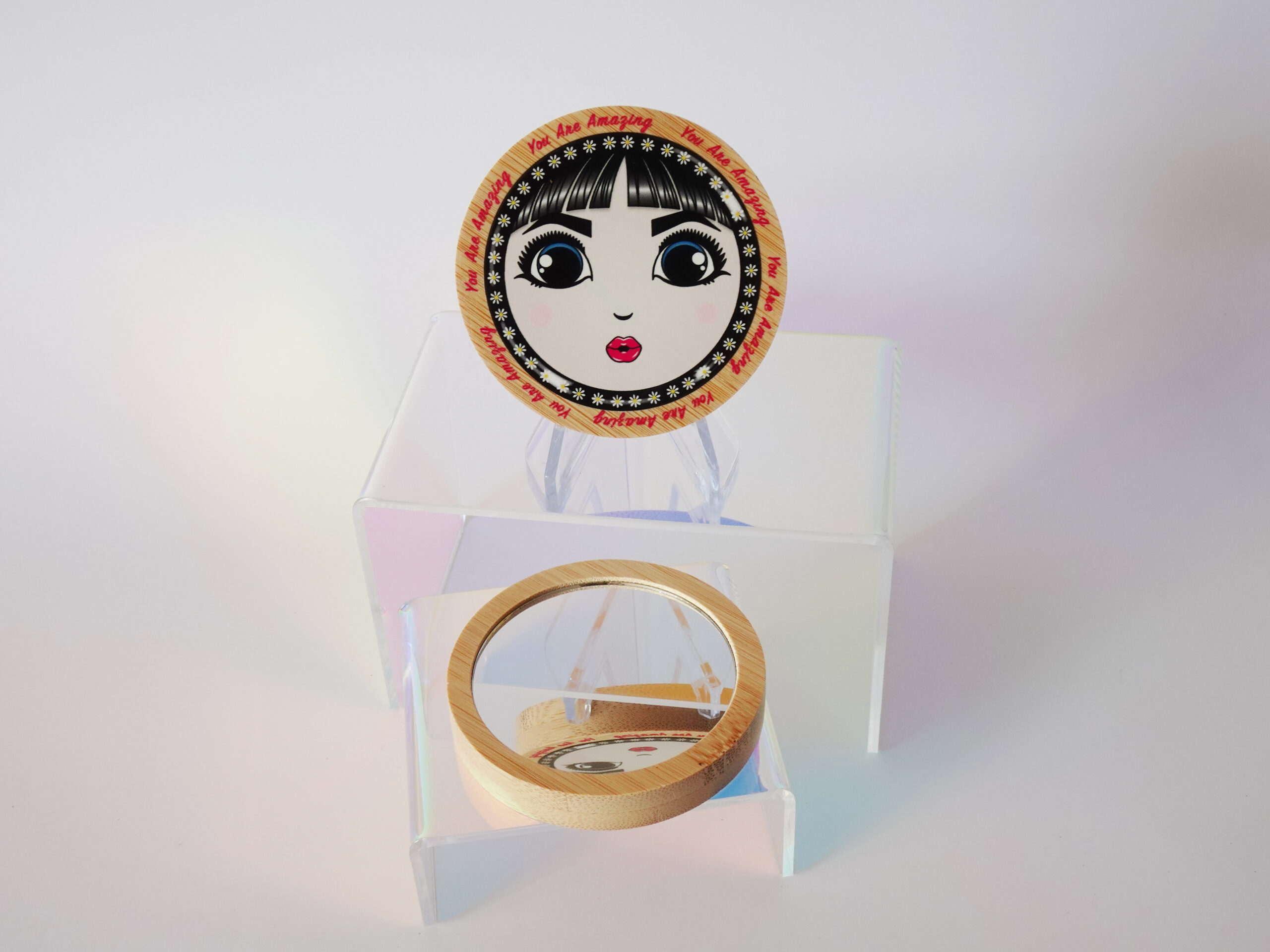 “You Are Amazing” bamboo pocket mirror featuring O’s face and retro lettering around the frame.