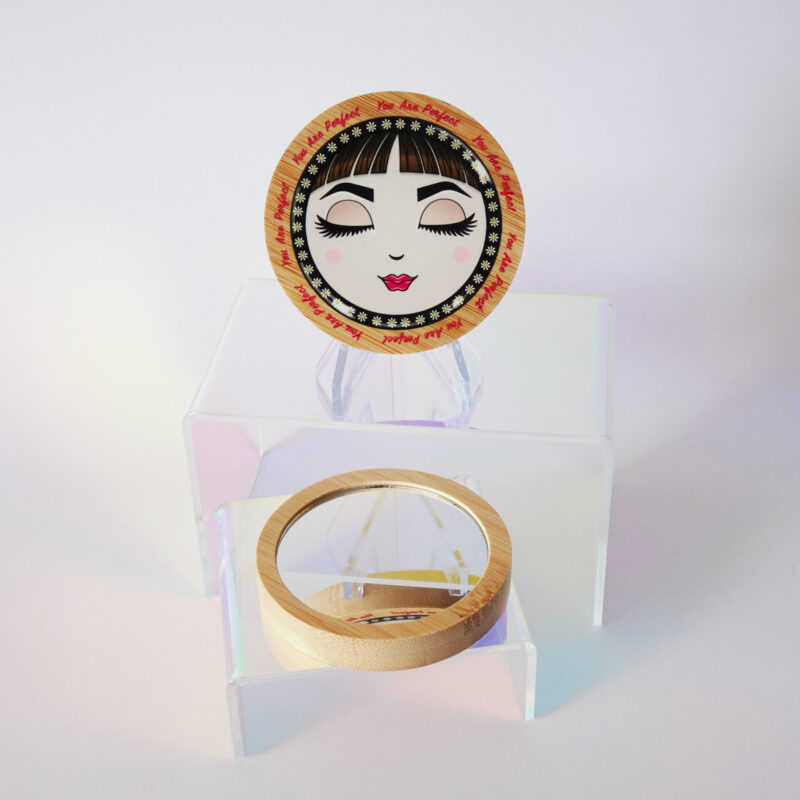 “You Are Perfect” bamboo pocket mirror featuring O with closed eyes and soft pink tones.