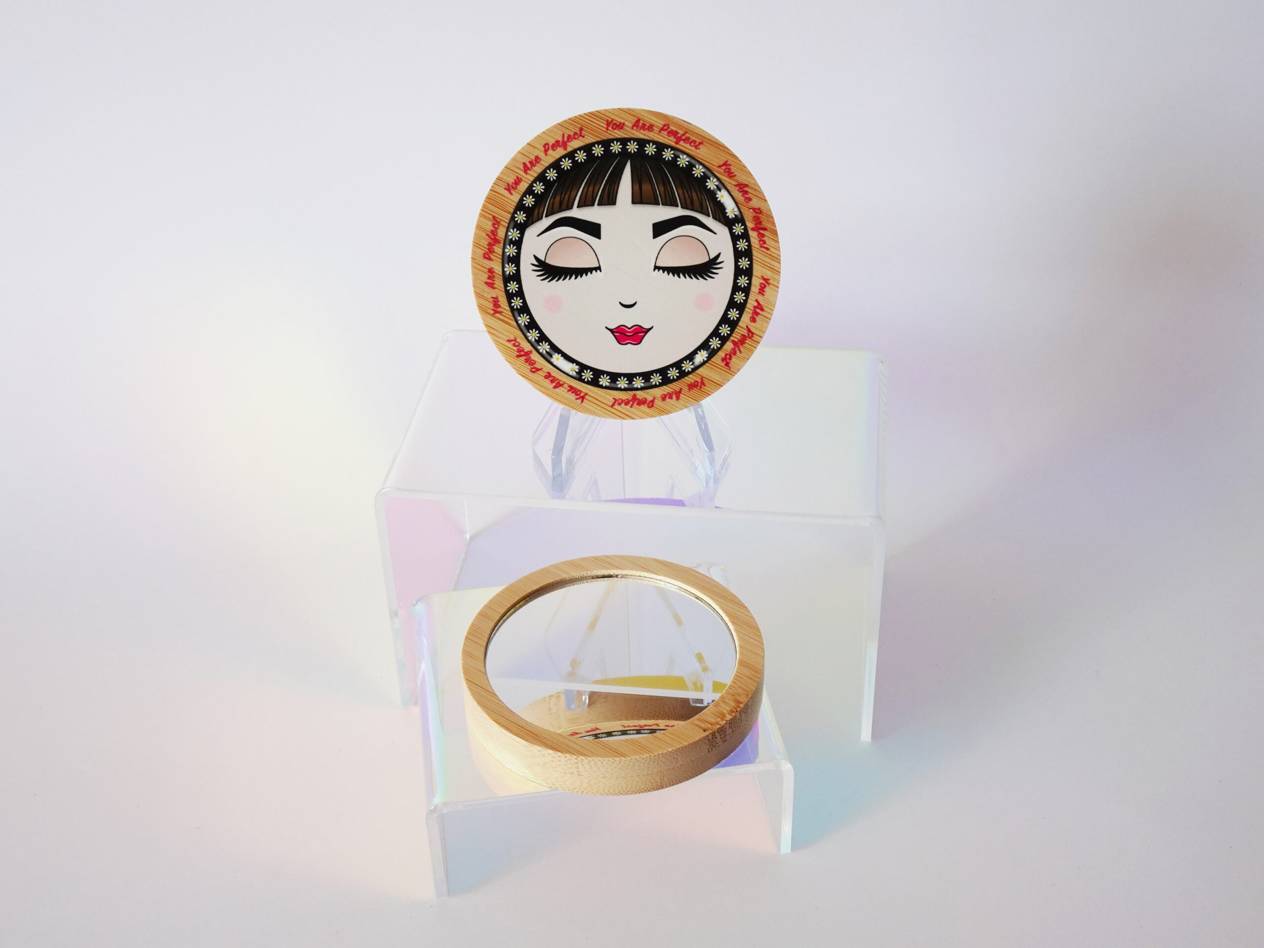 “You Are Perfect” bamboo pocket mirror featuring O with closed eyes and soft pink tones.
