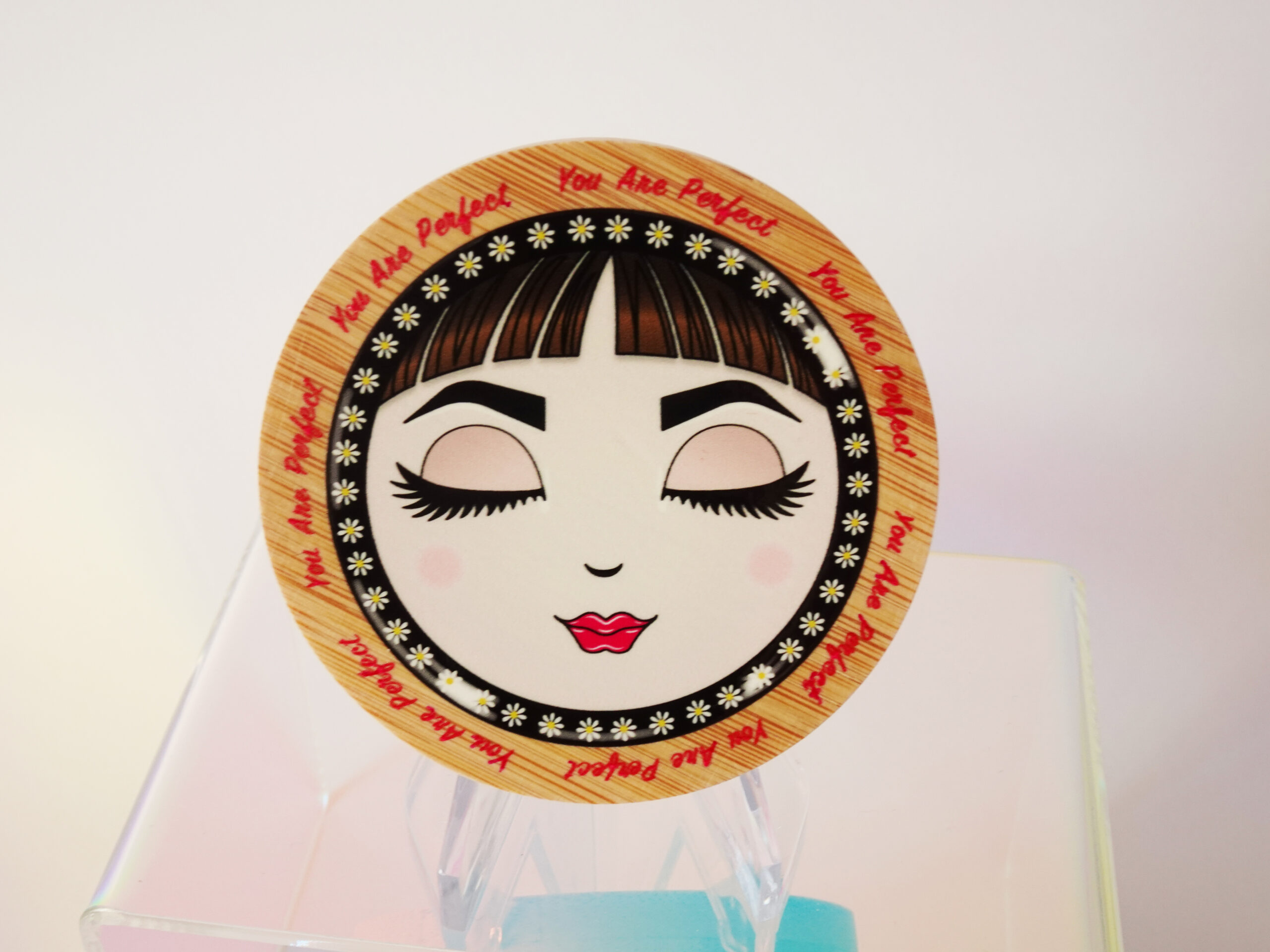 “You Are Perfect” bamboo pocket mirror featuring O with closed eyes and soft pink tones.