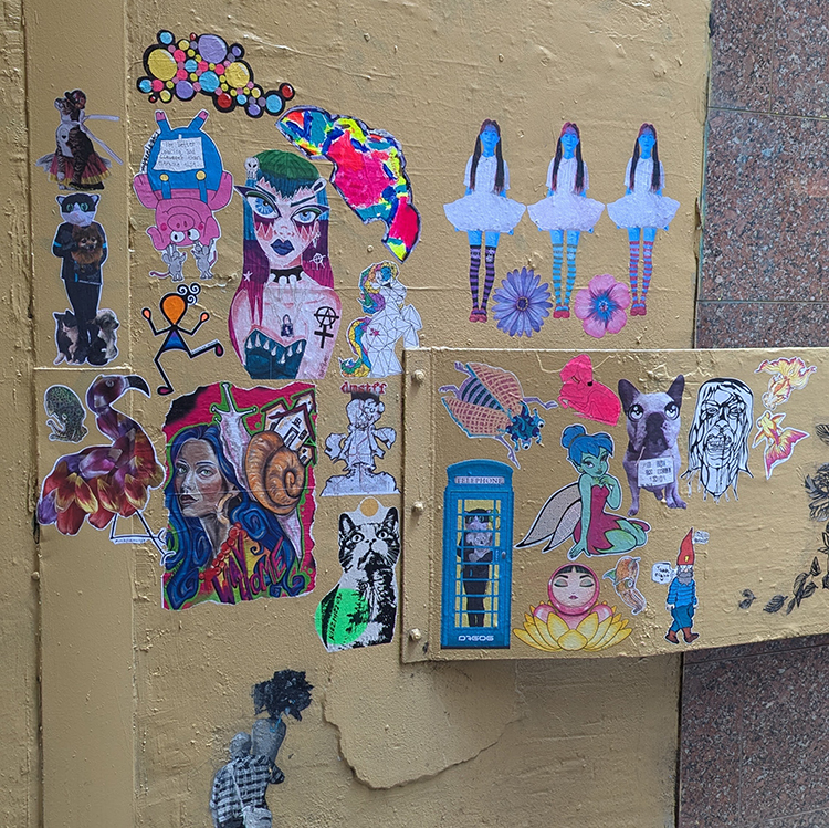 Wheatpaste street art of O by Alla K in Australia – pop surrealism with bold character design on urban architecture