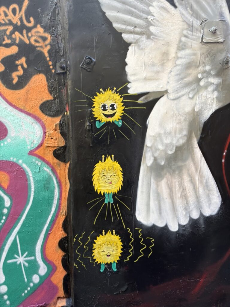 Wheat paste of EM bouncing into the air, pasted on a brick wall in Freeman Alley, NYC.