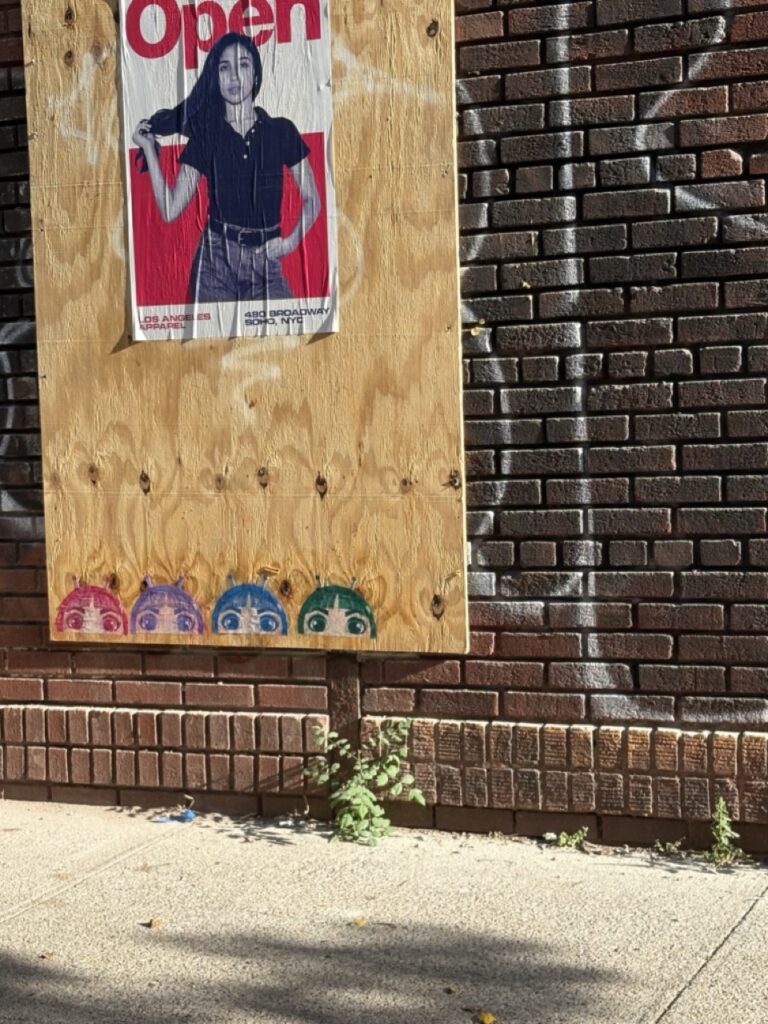 Wheat paste of O’s split tonal faces in black and white on a brick wall in Greenpoint, Brooklyn.