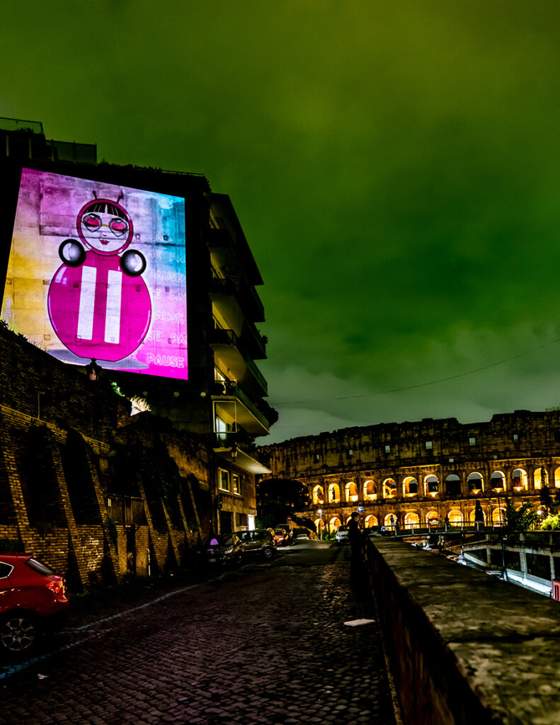 Projection of O on a building wall near the Colosseum in Rome, Italy.