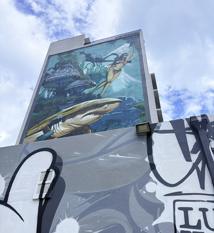 Vibrant Wynwood wall mural featuring a shark and woman, symbolizing courage and artistic rebirth