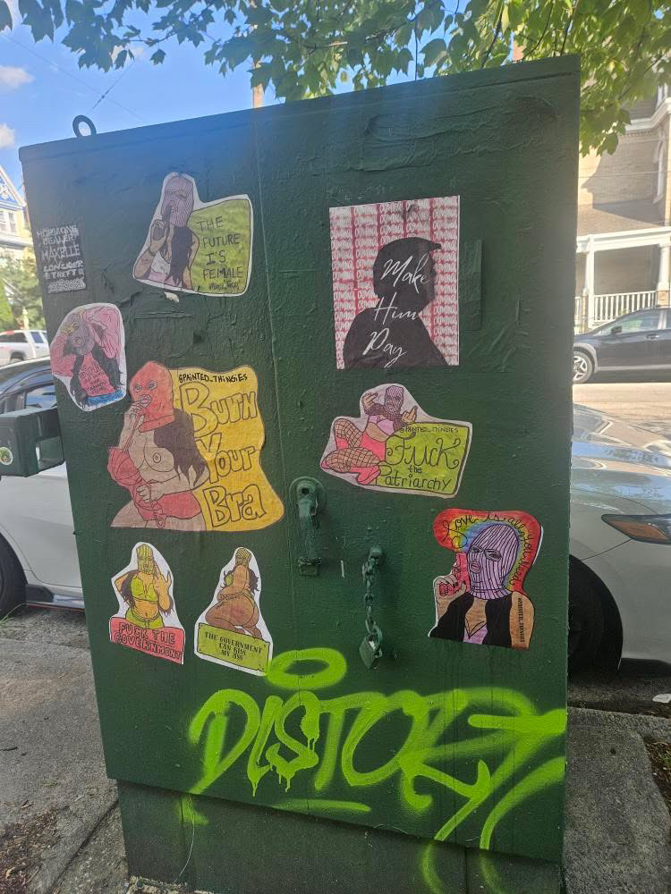 Street art by Alaina featuring hand-painted paste-ups and bold imagery centered on the female body, autonomy, and resistance in public space.